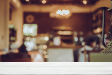 Empty wooden table blurred of restaurant cafe background and reception room, can be used for display or montage your products