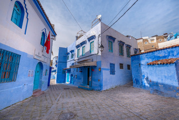 Fototapeta na wymiar Beautiful view of the blue city Chefchaouen, Morocco in the medina. Traditional moroccan architectural details and painted houses. street with door and bright blue walls with arch