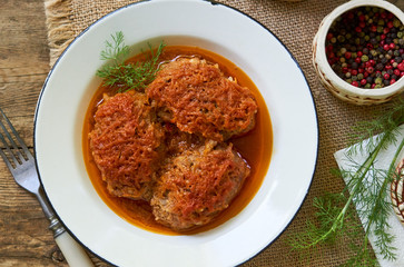 Meat cutlets with cabbage in tomato sauce