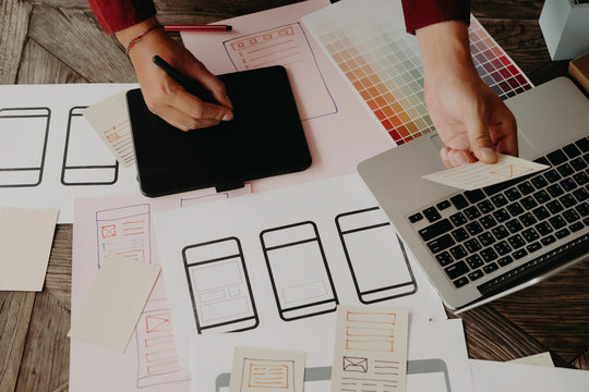 Web designer planning application for mobile phone. Design application development draft sketch drawing online Technology Content.User experience concept.