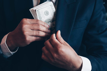 Asian business individual who owns the business sign personally sealing the deal with receiving a bribe money.The concept of corruption and anti bribery