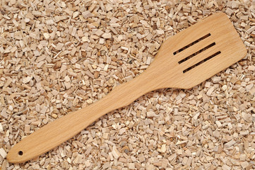 A beech kitchen spatula on a sliver layer
