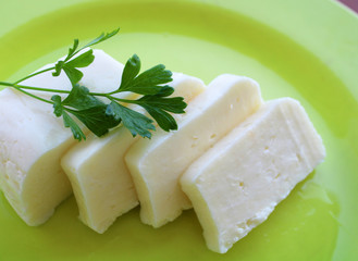 Fresh cheese on a plate, full fat cheese 