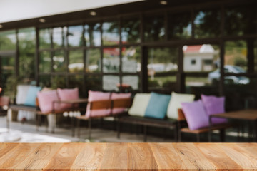 Empty wooden table blurred of restaurant cafe background and reception room, can be used for display or montage your products