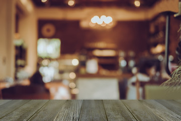 Empty wooden table blurred of restaurant cafe background and reception room, can be used for display or montage your products