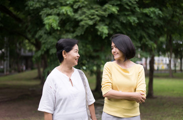 Obraz premium Senior asian older mother happy with daughter take care and support at outdoor