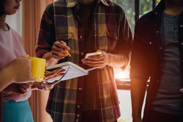 Asian business people meeting new startup project pointing graph discussion and analysis data charts and graphs.Business finances and accounting concept