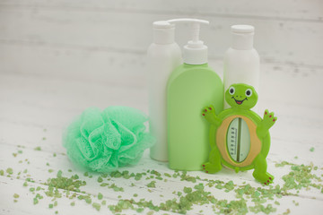 Bathing accessories. Green tubes and bottles for bath. Shower stuff. SPA for kids.