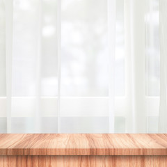 Empty of wooden table top on curtain and window background with blur of nature environment morning concept. Wood table and space for place your product or design.