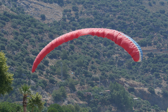 Dome of the parachute on the background of mountains overgrown with forest, summer, Oludeniz, Turkey,