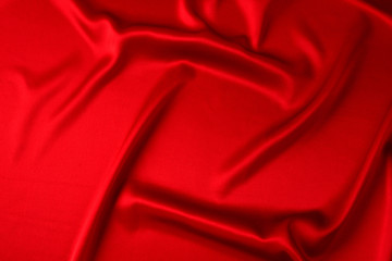 Red silk or satin luxury fabric texture can use as abstract background. Top view