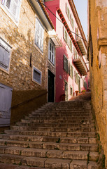 Fototapeta na wymiar Staircase with colorful houses in old town of Nafplio