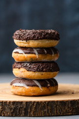 stack of chocolate donuts with frosting and sugar