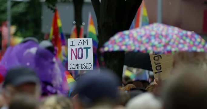 People Parading Through Streets With Rainbow Flags For Gay Rights With 'I Am Not Confused'  Sign Parading In Nottingham