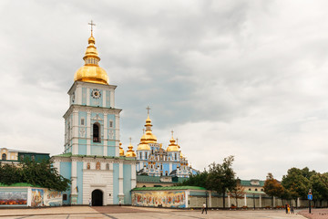 Fototapeta na wymiar St. Michael`s Golden-Domed Monastery with bell tower and church seen in front of St. Michael`s Square in Kyiv, Ukraine, view from the street.