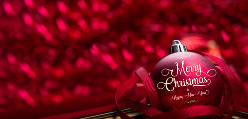 Merry christmas and happy new year red background.close up red decoration ball with blur tinsel at...