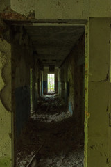 Fototapeta na wymiar Old abandoned corridor. Corridor in an abandoned house.