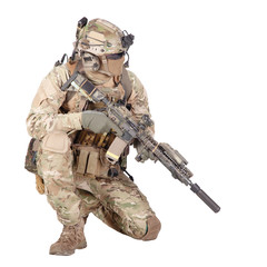 Soldier with rifle standing on knee studio shoot