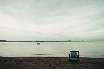 Sea with resort and beach chairs