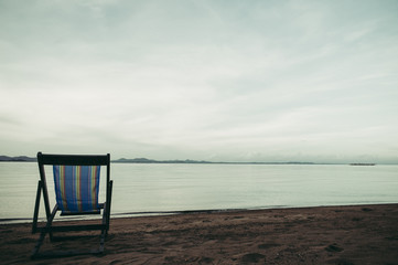 Sea with resort and beach chairs