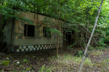 Fototapeta na wymiar The old building of the Soviet era. Garage in the Chernobyl region.