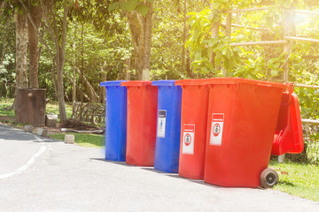 Garbage bins for recycling with recycle colors symbol in the park,Environmental pollution issues.