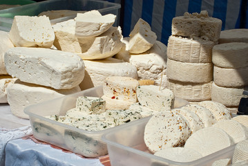 Different types of cheese on the table. Many cheese is sold at an agricultural fair. Natural home product.