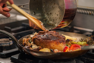 Cooking gurmet food, t-bone steak with vegetables.