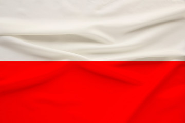 Fototapeta na wymiar national flag of the country of Poland on gentle silk with wind folds, travel concept, immigration, politics