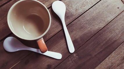 views top cup coffee with spoon on wood background