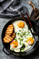 fried eggs in a cast iron pan top view