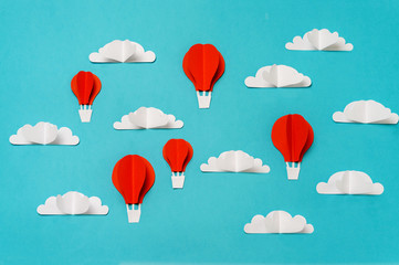 Red hot air balloons in sky paper cut and origami objects. Creative concept for banner/landing/background designs.