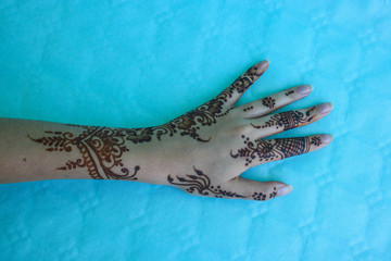 henna drawed at woman hand