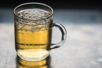 Delicious cold drink. Glass with ice cubes. Fresh icy cold cool freshening liquid. Beautiful background.