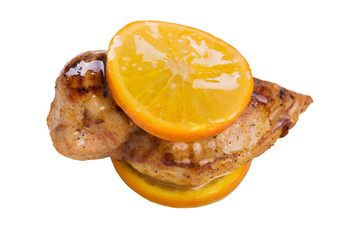 baked chicken or turkey, in orange sauce, on a white background