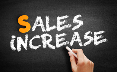 Fototapeta premium Sales Increase text on blackboard, business concept background