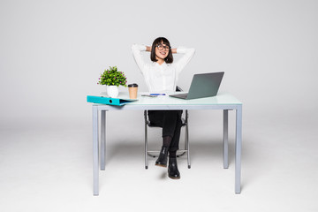 Business woman relaxing with her hands behind her head and sitting on chair