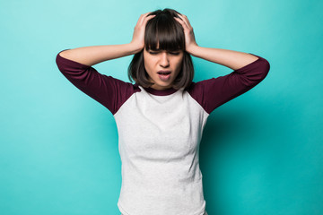 Beautiful woman over blue isolated background suffering from headache desperate and stressed because pain and migraine.