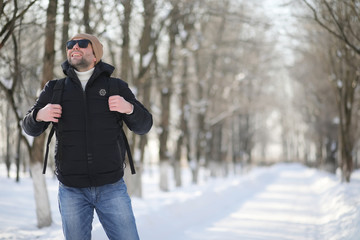 Fototapeta na wymiar A man with a backpack frosty winter