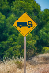 Caution road trains ahead street sign in Australia