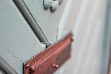 Detailed closeup of ancient wooden door with brass