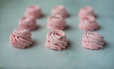 Meringue zephyr marshmallows on a light background. Pink sweet homemade marshmallow. meringue on white background.