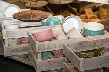 set of ceramic tableware in wooden boxes in kitchen