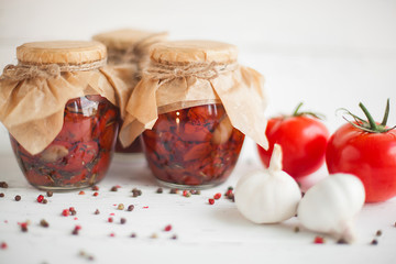 Tomatoes in the jar. Homemade sun dried tomatoes. temporary closing-down. Summer and autumn canned food. conserve with spices and vegetables.