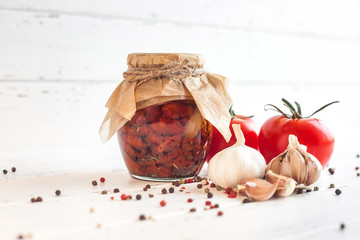 Tomatoes in the jar. Homemade sun dried tomatoes. temporary closing-down. Summer and autumn canned food. conserve with spices and vegetables.