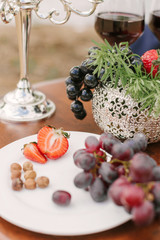 Fruit on a white plate, dessert on a Banquet table in the open air. Selective focus