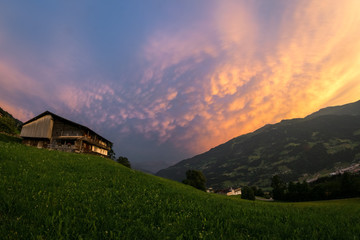 Colorful mammatus clouds of a thunderstorm over the european Alps at sunset