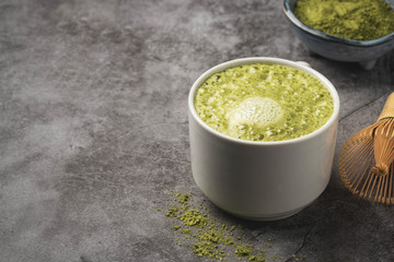 Latte matcha coffee. Japanese matcha green tea powder, a healthy natural product, antioxidant. Gray background, close-up, copy space.