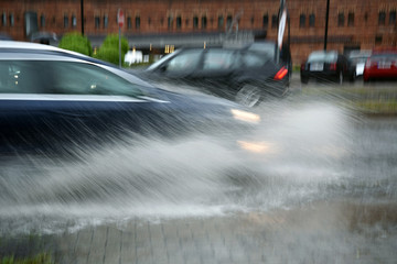 Cars on street after rain.