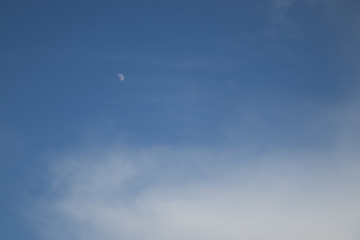 Fototapeta na wymiar Growing moon on blue sky